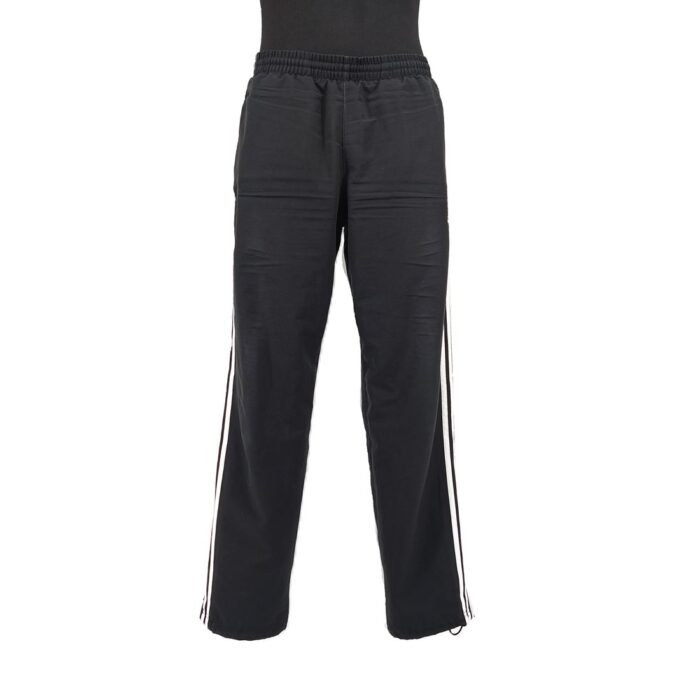 Front view of vintage Adidas black track pants with side stripes